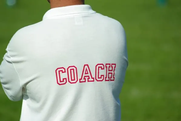 The back of a coach’s shirt, lettered COACH